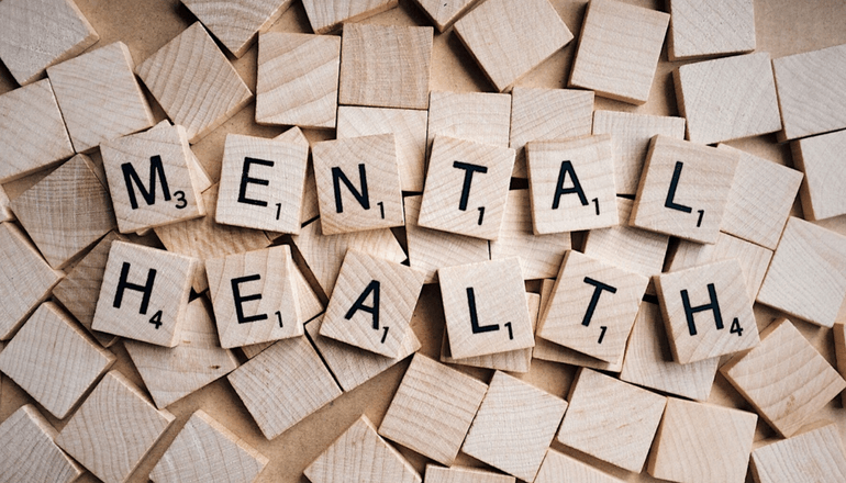 Scrabble game pieces which spell out "Mental Health"